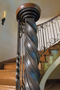 Elegant spiral staircase with ornate metal railing.