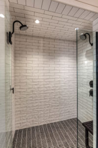 Modern tiled shower with dual showerheads.