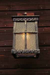 Rustic metal lantern on wooden wall