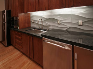 Modern kitchen with textured backsplash design.