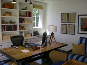 Elegant home office with wooden desk and shelves