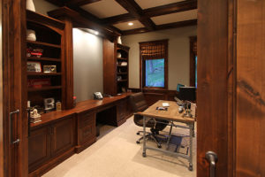 Everwell Bay Remodel Home office with wooden furniture and desk setup.