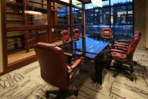 Modern conference room with red chairs.