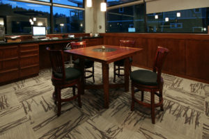 Cozy office lounge with wooden table and chairs.