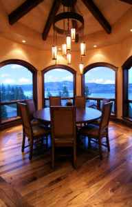 Elegant dining room with wooden table and lake view.