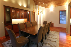 Elegant dining room with wooden table and chairs.