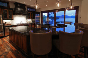 Everwell Bay Remodel Luxurious kitchen with lake view at dusk
