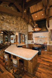 Rustic kitchen with stone and wooden elements.