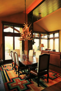 Rustic dining room with antler chandelier
