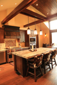 Rustic kitchen with island and pendant lights.