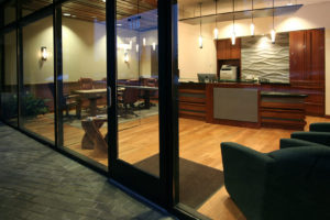 Modern office lobby with glass doors and wooden accents.