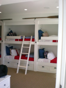 Bunk bed room with ladder and colorful pillows