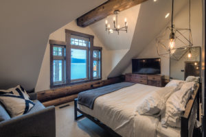 Cozy bedroom with lake view and modern lighting.