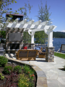 Lakefront pergola with cozy outdoor seating area.