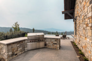 Outdoor BBQ area with scenic mountain view.