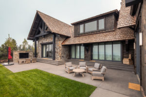 Modern rustic home with outdoor patio seating.