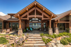 Rustic lakeside cabin with stone entryway.