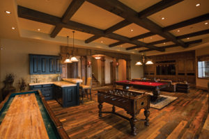 Luxurious game room with billiards and foosball.