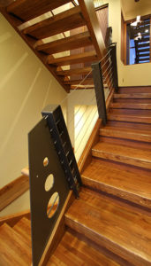 Liberty Lake Residence Modern wooden staircase with metal railing design.