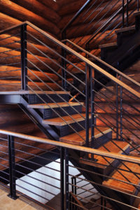 Modern wooden and metal staircase in a cabin.