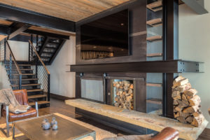 Modern loft with fireplace and stylish staircase.