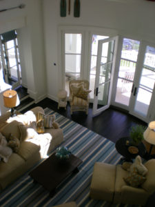 Cozy living room with striped rug and glass doors.