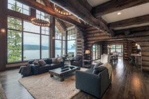 Rustic log cabin living room with lake view.