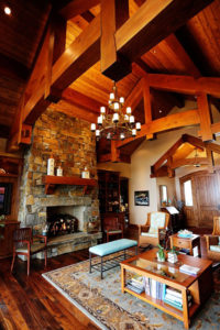 Cozy rustic living room with stone fireplace.