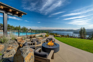Scenic lakeside patio with fire pit and pool.