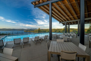 Outdoor pool with scenic lake view.