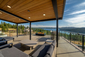 Covered patio with scenic lake and forest view.