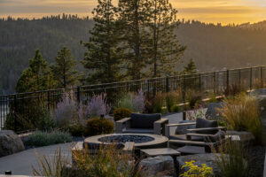 Outdoor patio with chairs and scenic mountain view.