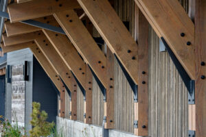 Wooden roof beams with metal brackets.