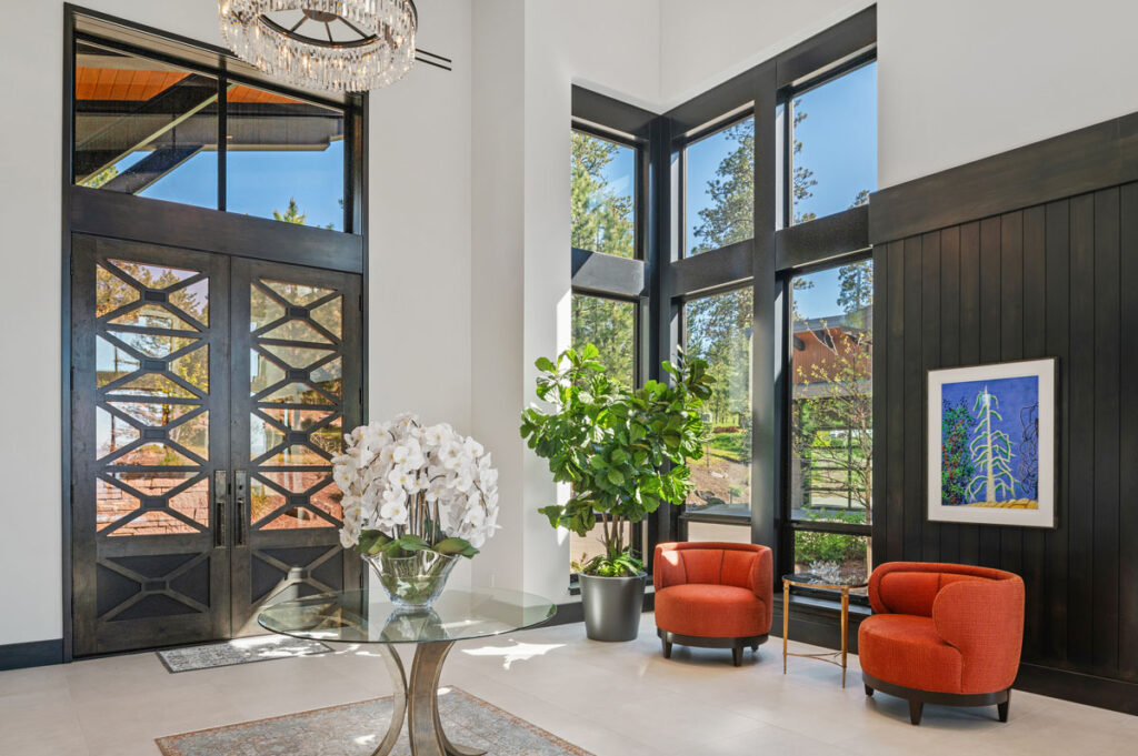 Modern entryway with large windows and decor.