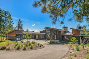 Black Rock Residence #6 Modern home surrounded by trees and blue sky.