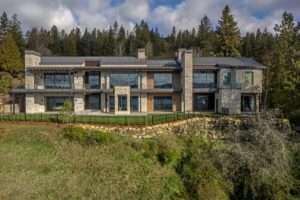 Black Rock Residence #7 Exterior of Black Rock Residence #7 set into the hillside above Lake Coeur d'Alene, with stone cladding and a standing seam metal roof