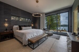 Black Rock Residence #7 Guest suite with a textured feature wall, sculptural ring pendant and lake views