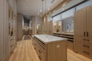 Black Rock Residence #7 Custom dressing room with oak millwork, a center island and integrated lighting